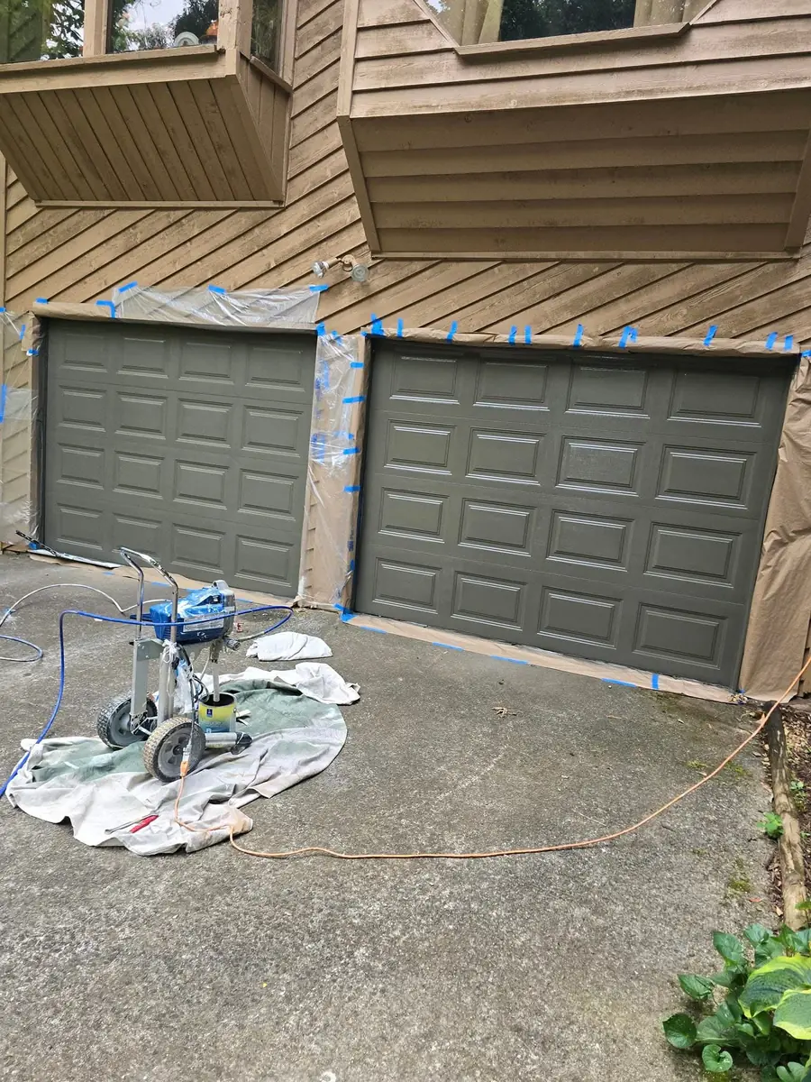 Garage doors and exterior trim masked during painting