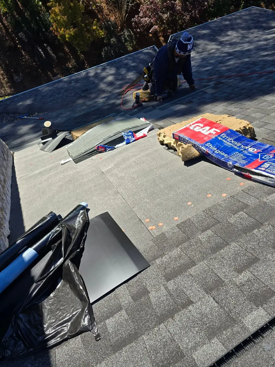 Crew installing shingles during re-roofing